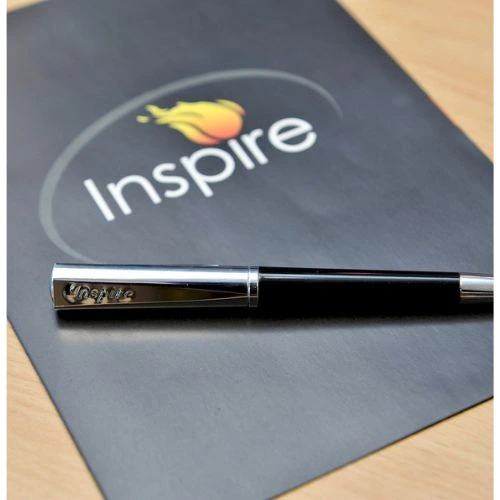  A sleek pen positioned on a black notebook, representing the essence of smart graphics and printing.